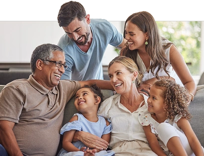 Family members smiling and enjoying a warm moment in a living room